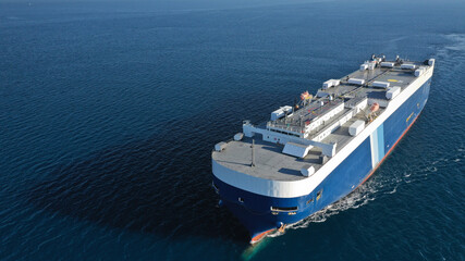 Aerial drone photo of huge car carrier ship RO-RO (Roll on Roll off) cruising in Mediterranean deep blue Aegean sea