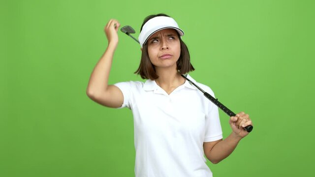 Young brunette woman playing golf and thinking over isolated background. green screen chroma key
