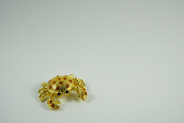 jewelry gold crab on a light background close