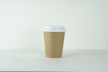 A take-away paper cup on a table.