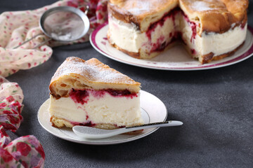 Karpatka with cherries, traditional Polish cream pie on dark gray background.