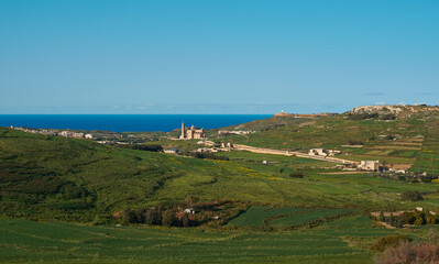 Fototapeta na wymiar Ta Dbiegi and Ta Pinu with Ghasri village in the background. Gozo, Malta