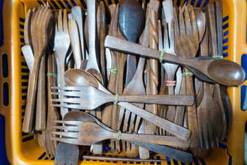Wooden spoon and fork for sale isolated in a basket