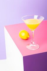 Refreshing yellow lemon cocktail in glass on table
