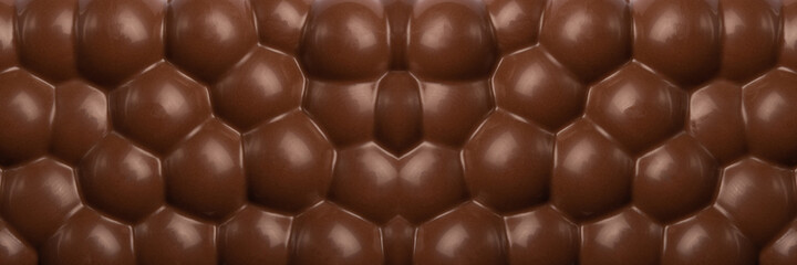 Milk chocolate bar, banner design. Chocolate texture close-up. Chocolate seamless background.