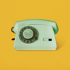 Retro vintage rotary telephone isolated on yellow background pop art