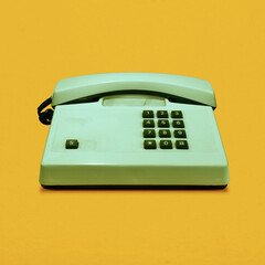 Retro vintage push-button telephone isolated on yellow background pop art
