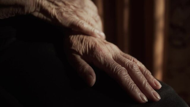 Wrinkled hands of an old senior woman.