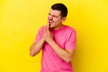 Young caucasian cool man isolated on yellow background having a strong teeth pain, molar ache.