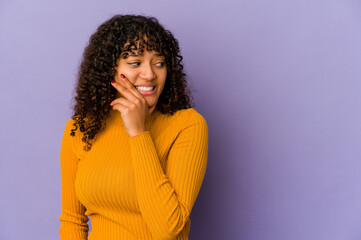 Young african american afro woman isolated touching back of head, thinking and making a choice.