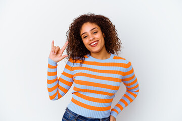 Young african american woman isolated on white background showing a horns gesture as a revolution concept.