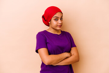 Young african american woman isolated on beige background unhappy looking in camera with sarcastic expression.