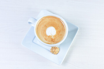 Cup of colombian coffee, decorated on white wooden background