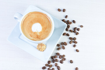 Cup of colombian coffee, decorated on white wooden background