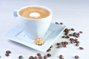 Cup of colombian coffee, decorated on white wooden background
