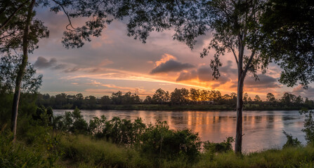 Beautiful Panoramic Riverside Sunset with Dramatic Sky and Reflections