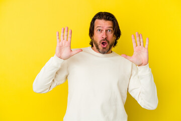 Middle age caucasian man isolated on yellow background having an idea, inspiration concept.