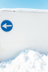 One way obligatory direction traffic sign in the snow