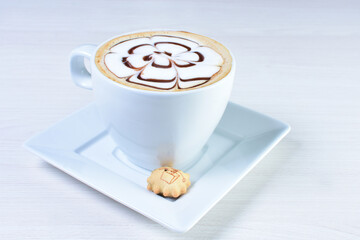 Cup of colombian coffee, decorated on white wooden background