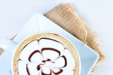 Cup of colombian coffee, decorated on white wooden background