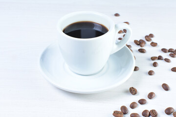 Cup of colombian coffee, decorated on white wooden background