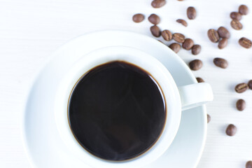 Cup of colombian coffee, decorated on white wooden background