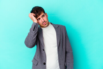 Young caucasian man isolated on blue background being shocked, she has remembered important meeting.