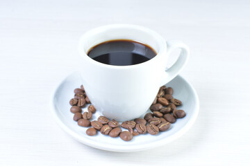 Cup of colombian coffee, decorated on white wooden background
