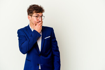 Young business caucasian man isolated on white background thoughtful looking to a copy space covering mouth with hand.