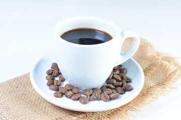 Cup of colombian coffee, decorated on white wooden background