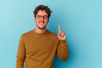 Young caucasian man wearing eyeglasses isolated on blue background showing number one with finger.