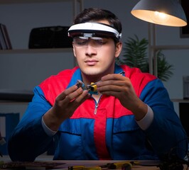 Computer specialist repairing PC late at night