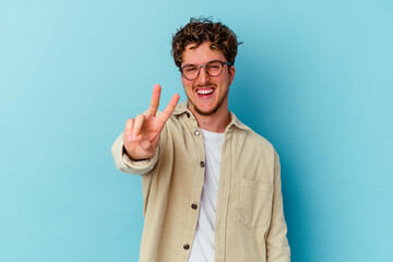 Young caucasian man wearing eyeglasses isolated on blue background showing number two with fingers.