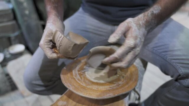 Making a handmade clay pot in the workshop. Pottery lesson with master.