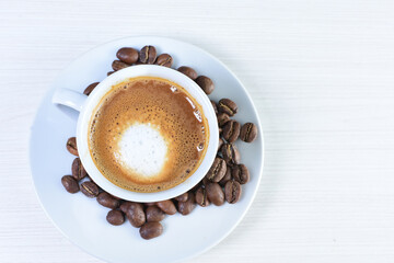 Cup of colombian coffee, decorated on white wooden background