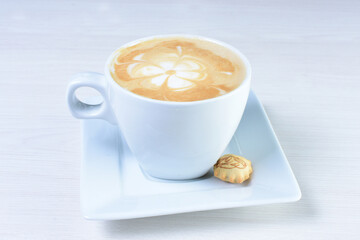 Cup of colombian coffee, decorated on white wooden background