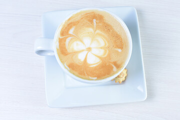 Cup of colombian coffee, decorated on white wooden background
