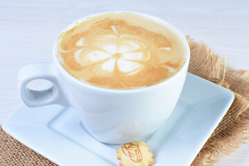 Cup of colombian coffee, decorated on white wooden background