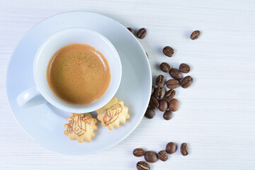 Cup of colombian coffee, decorated on white wooden background