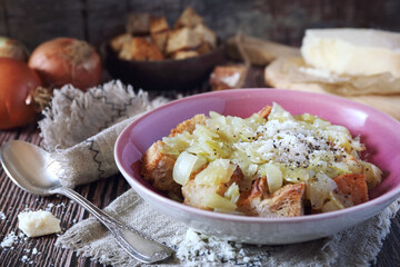 Italian Cuisine. Roman onion soup with bread and grated cheese