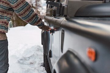 Hand opening the door of an off-road vehicle