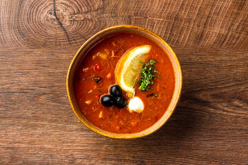 Dishes of Russian and Ukrainian cuisine. Solyanka soup in a clay plate