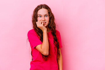 Little caucasian girl isolated on pink background biting fingernails, nervous and very anxious.