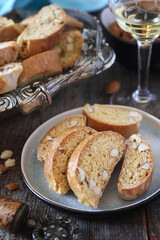 Italian cookies: almond cantuccini and glass of white wine