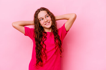Little caucasian girl isolated on pink background feeling confident, with hands behind the head.