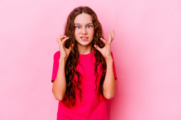 Fototapeta premium Little caucasian girl isolated on pink background upset screaming with tense hands.