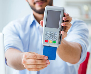 Man processing credit card transaction with POS terminal
