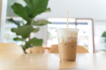 Cold ice milk coffee in a plastic cup