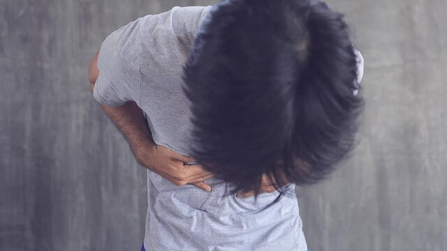 young asian man touching stomach painful suffering from stomachache appendicitis or gastrointestinal system disease