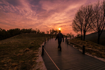Lone male walking along the path at the ridge of Achasan Mountain in Seoul, Korea during early evening.